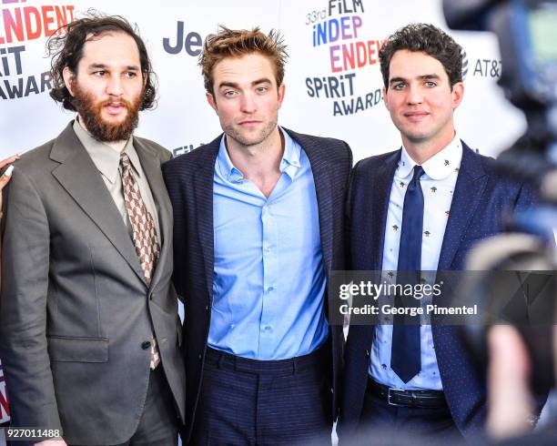 Director Josh Safdie, actor Robert Pattinson, and director Benny Safdie attend the 2018 Film Independent Spirit Awards on March 3, 2018 in Santa...