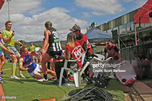 Brittany Bonnici of the Magpies is pushed into the fence by Emma Kearney of the Bulldogs during the round five AFLW match between the Collingwood...