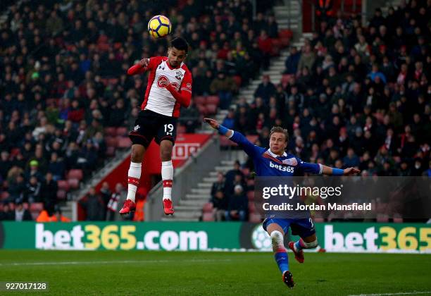 Sofiane Boufal of Southampton heads the ball under pressure from Moritz Bauer of Stoke during the Premier League match between Southampton and Stoke...