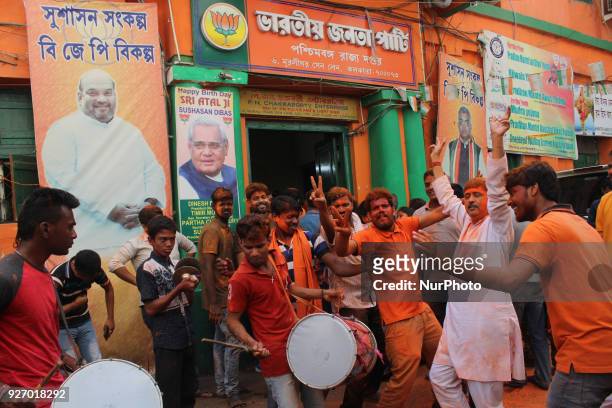Indian supporters of the Bharatiya Janata Party celebrate at a rally following state election victories, outside the BJP Political State Party Office...