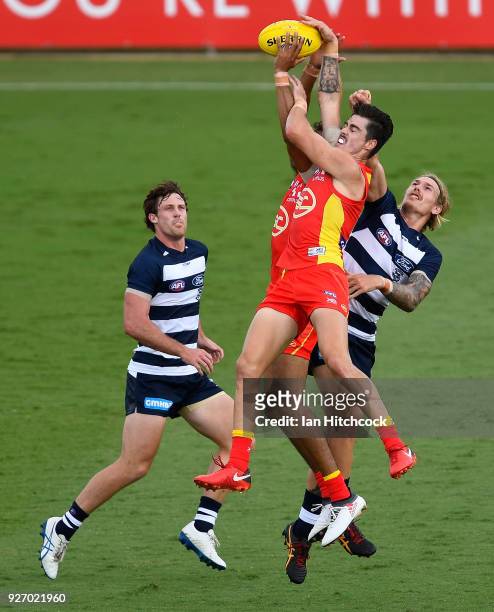 Alex Sexton of the Suns attmpts to take a mark in front of Tom Stewart of the Cats during the AFL JLT Community Series match between the Geelong Cats...