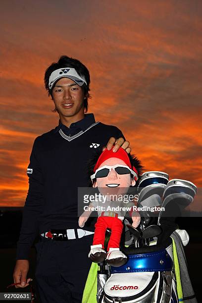 Ryo Ishikawa of Japan poses for a photograph with a headcover bearing his likeness during the pro-am prior to the start of the WGC-HSBC Champions at...