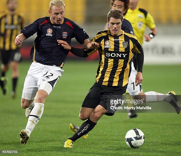 Tony Lochhead of the Phoenix holds off Jobe Wheelhouse of the Jets during the round 10 A-League match between the Wellington Phoenix and the...