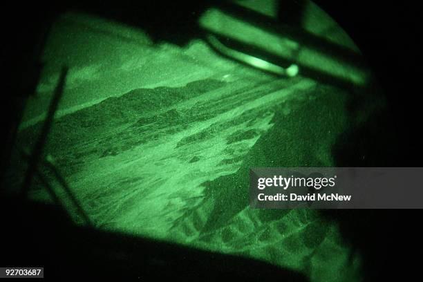 The view through Display Night Vision Goggles illuminates the desert as seen by pilots flying by DNVGs as members of the UK's Royal Air Force fly...