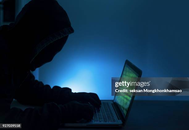 payments system hacking. online credit cards payment security concept. hacker in black gloves hacking the system. - scam stock-fotos und bilder