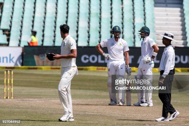 Australian bowler Mitchell Starc sledges South African batsman Theunis de Bruyn during the fourth day of the first Test cricket match between South...