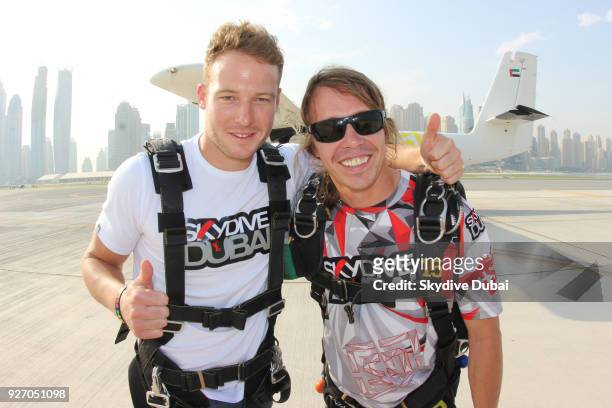 Cricketer David Miller poses with his tandem instructor prior to boarding the plane at Skydive Dubai's Palm dropzone on September 1, 2015 in Dubai,...