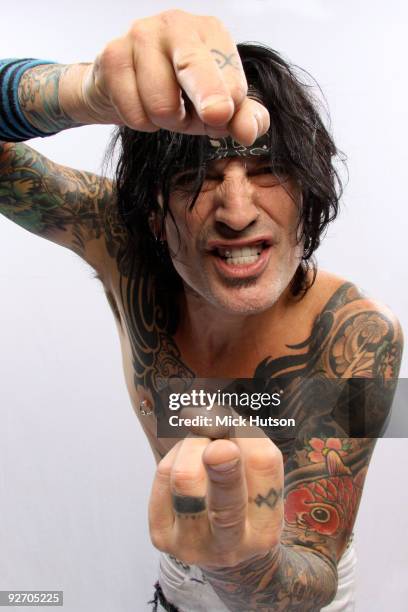 Tommy Lee of Motley Crue poses for a studio portrait session, raising hs middle fingers, backstage at the Download Festival, Donington Park,...
