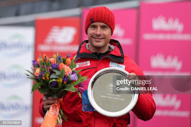 Switzerland's Marcel Hug poses with the trophy after winning the men's elite wheelchair race during the inaugural The Big Half festival in London on...