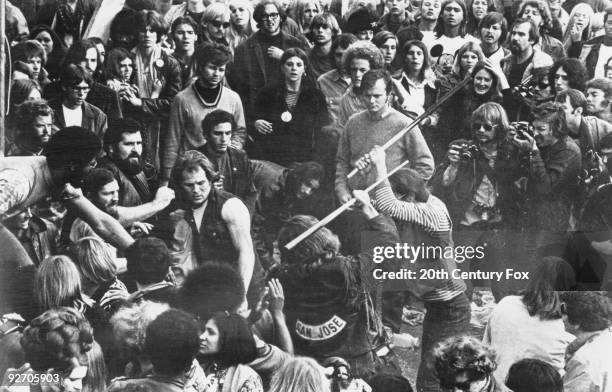 Still from the documentary film 'Gimme Shelter', showing audience members looking on as Hells Angels beat a fan with pool cues at the Altamont Free...
