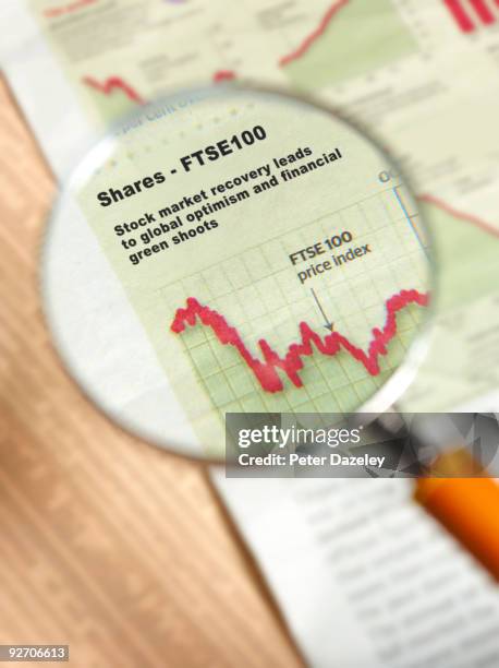 shares ftsa 100 under magnifying glass. - ftse stock pictures, royalty-free photos & images