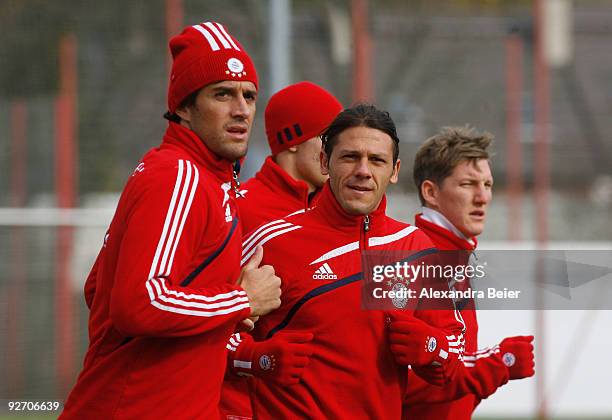 Luca Toni, Martin Demichelis and Bastian Schweinsteiger of Bayern Muenchen warm up during a training session on November 4, 2009 in Munich, Germany....