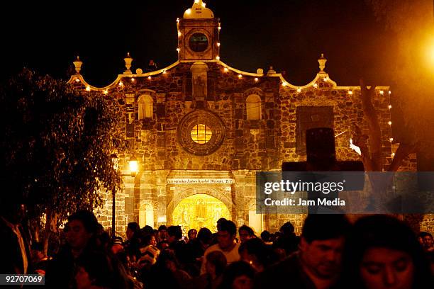 Locals attend the Dia de los Muertos celebrations at the cemetery on November 2, 2009 in Mixquic, Mexico.