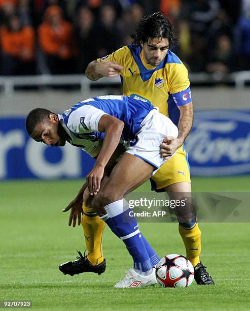 Apoel Nicosia's captain Marinos Stasias competes with FC Porto's Fernando during their UEFA Champions League group D football match at the GSP...