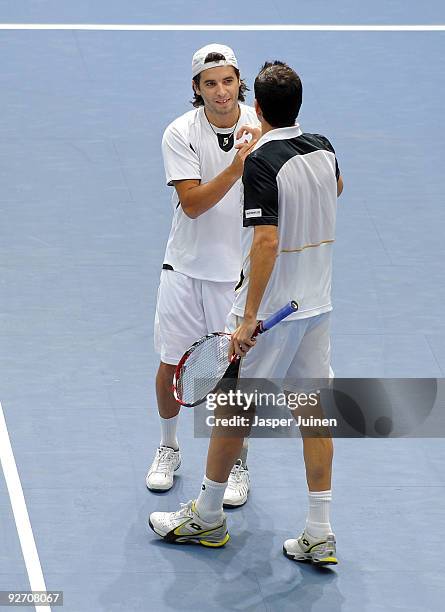 Albert Montanes of Spain celebrates with his fellow countryman and doubles partner Guillermo Garcia-Lopez their second round doubles win over Julian...