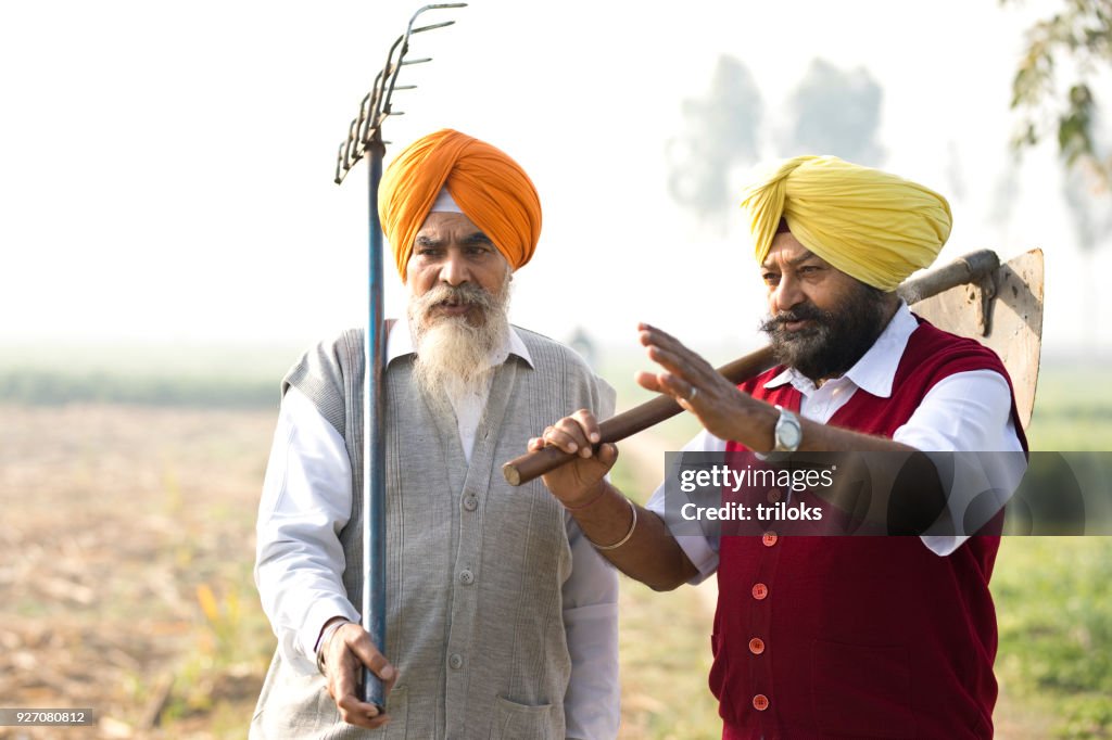 Two Indian farmers discussing on field