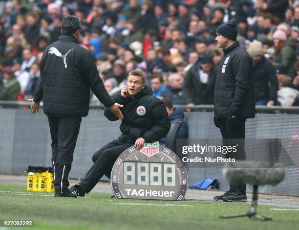 Huddersfield Town manager David Wagner having words with Injured Referee Michael Jones during the Premiership League match between Tottenham Hotspur...