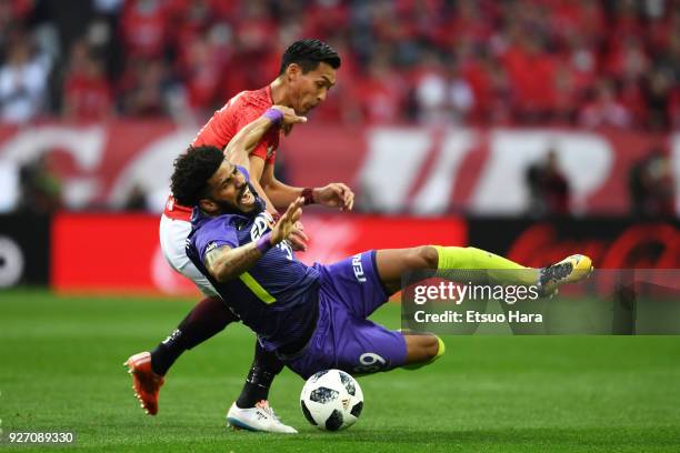 Tomoaki Makino of Urawa Red Diamonds and Patric of Sanfrecce Hiroshima compete for the ball during the J.League J1 match between Urawa Red Diamonds...