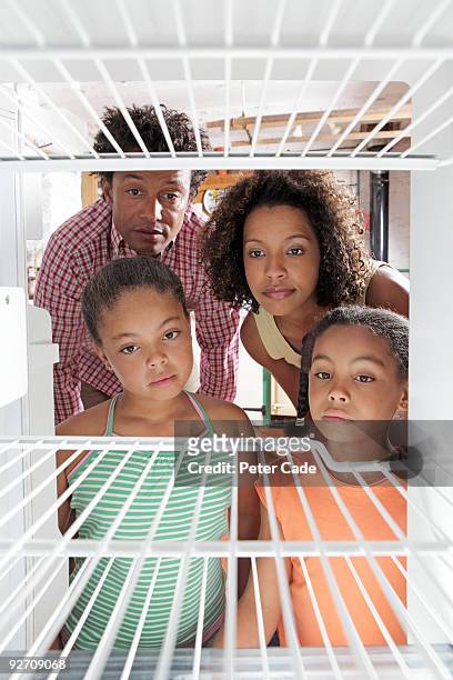 family looking in empty fridge - refrigerator front stock pictures, royalty-free photos & images