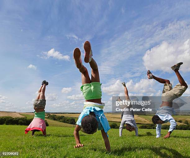 family outdoors doing handstands - handstand stock pictures, royalty-free photos & images