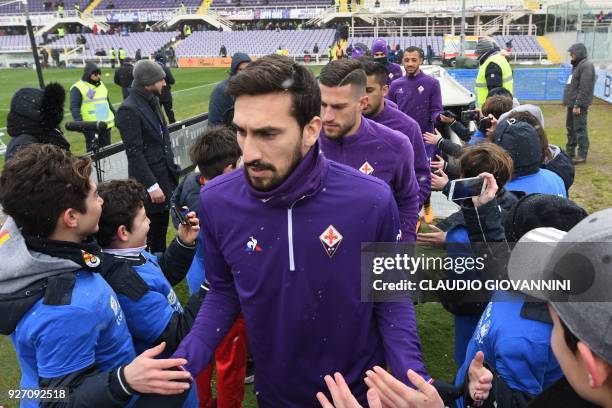 Fiorentina's captain Davide Astori and teammates enter the pitch on February 25, 2018 before the Italian Seria A football match Fiorentina vs Chievo,...