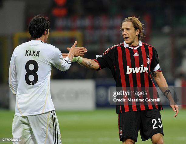 Massimo Ambrosini of AC Milangives five with Ricardo Kaka of Real Madrid after the UEFA Champions League group C match between AC Milan and Real...