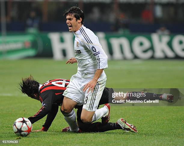 Massimo Oddo of AC Milan battles for the ball against Ricardo Kaka of Real Madrid during the UEFA Champions League group C match between AC Milan and...