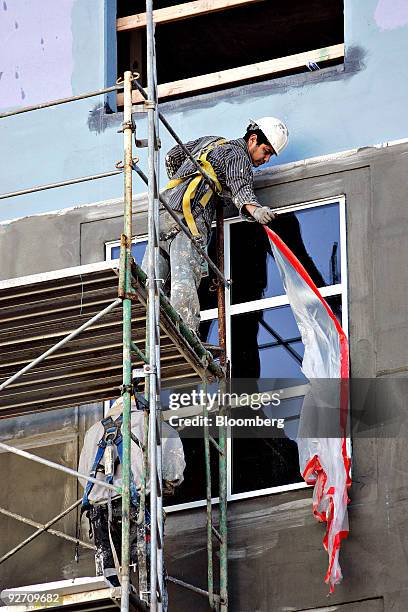 Construction workers install windows at an Embassy Suites Hotel under construction in Raleigh, North Carolina, U.S., on Tuesday, Nov. 3, 2009....