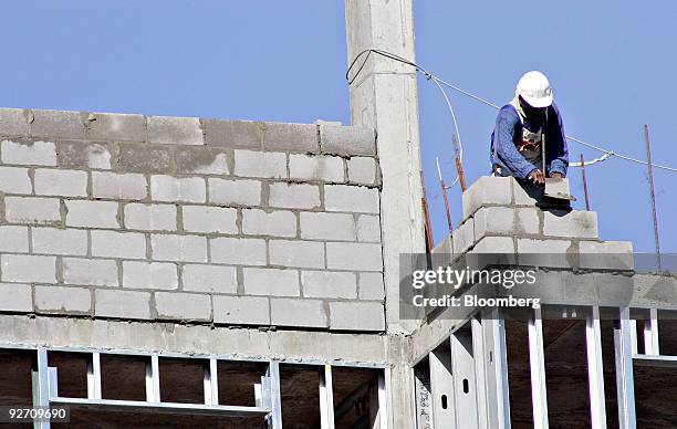 Mason sets concrete blocks at an Embassy Suites Hotel under construction in Raleigh, North Carolina, U.S., on Tuesday, Nov. 3, 2009. Construction...