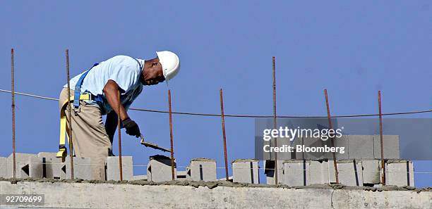 Mason sets concrete blocks at an Embassy Suites Hotel under construction in Raleigh, North Carolina, U.S., on Tuesday, Nov. 3, 2009. Construction...