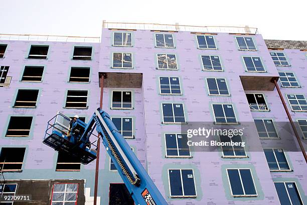 Construction workers install windows at an Embassy Suites Hotel under construction in Raleigh, North Carolina, U.S., on Tuesday, Nov. 3, 2009....