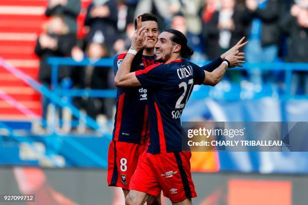 Caen's French forward Enzo Crivelli celebrates with Caen's Belgian midfielder Stef Peeters after scoring a goal during the French L1 football match...