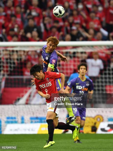 Toshihiro Aoyama of Sanfrecce Hiroshima and Yuki Muto of Urawa Red Diamonds compete for the ball during the J.League J1 match between Urawa Red...