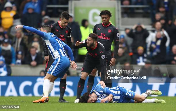 Matias Ezequiel Schelotto of Brighton and Hove Albion lays on the floor injured following a clash with Sead Kolasinac of Arsenal during the Premier...