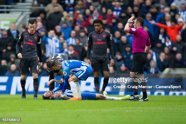 Players check on an apparently unconscious Brighton & Hove Albion's Matias Ezequiel Schelotto during the Premier League match between Brighton and...