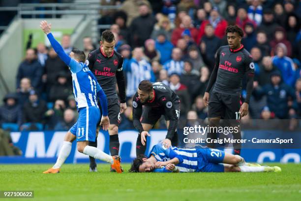 Players check on an apparently unconscious Brighton & Hove Albion's Matias Ezequiel Schelotto during the Premier League match between Brighton and...