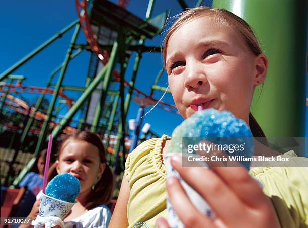 girls at a fairground. - shaved ice stockfoto's en -beelden