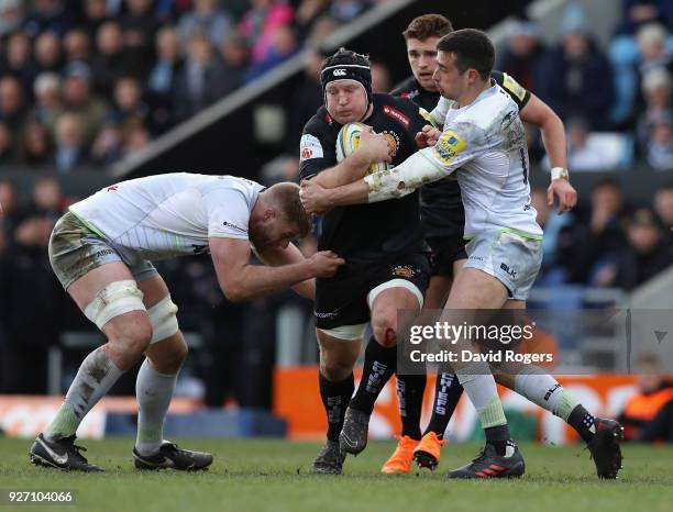 Thomas Waldrom of Exeter is held by Alex Lozowski during the Aviva Premiership match between Exeter Chiefs and Saracens at Sandy Park on March 4,...