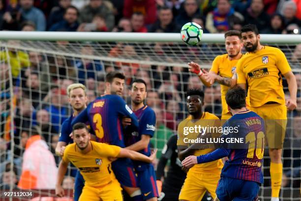 Barcelona's Argentinian forward Lionel Messi kicks the ball and scores during the Spanish league football match FC Barcelona against Club Atletico de...