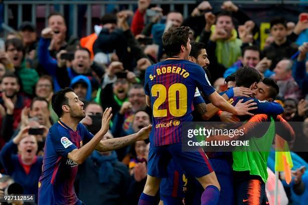 Barcelona's Argentinian forward Lionel Messi celebrates with teammates after scoring during the Spanish league football match FC Barcelona against...