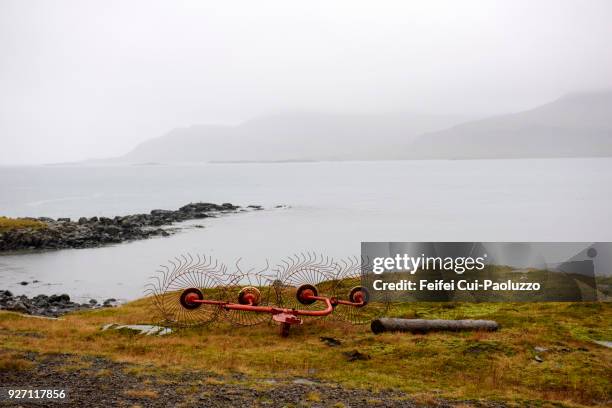 agricultural machine at seaside of breiddalsvik, eastern iceland - fog machine stock pictures, royalty-free photos & images