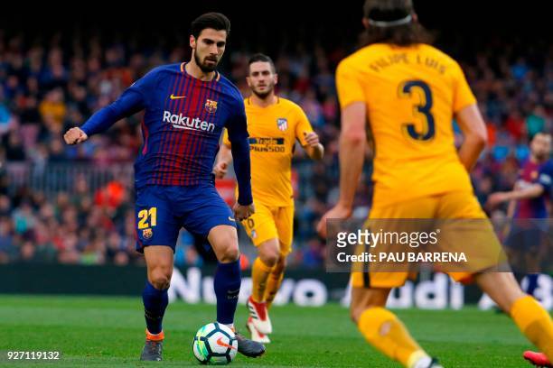 Barcelona's Portuguese midfielder Andre Gomes vies with Atletico Madrid's Brazilian defender Filipe Luis during the Spanish league football match FC...