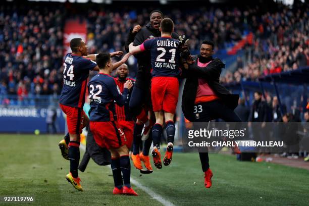 Caen's French defender Frederic Guilbert celebrates with teammates after scoring a goal during the French L1 football match between Caen and...