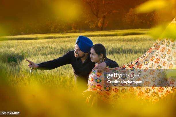 young couple pointing and looking out - punjab stock pictures, royalty-free photos & images