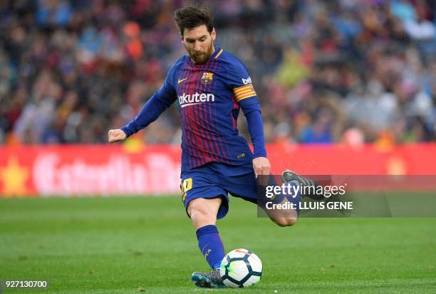 Barcelona's Argentinian forward Lionel Messi kicks the ball during the Spanish league football match FC Barcelona against Club Atletico de Madrid at...