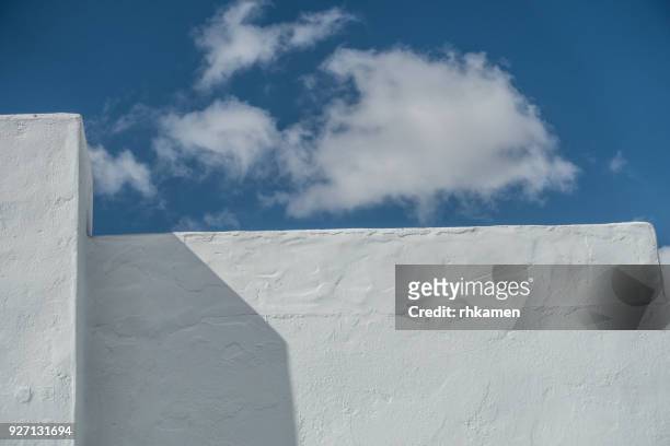 white wall and clouds, lanzarote, canary islands, spain - whitewashed photos et images de collection