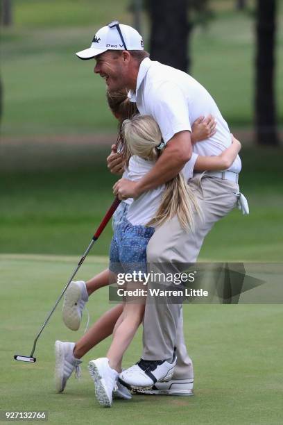 George Coetzee of South Africa is congratulated by his sisters on the 18th green after winning the Tshwane Open at Pretoria Country Club on March 4,...