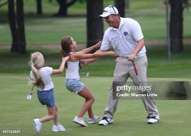 George Coetzee of South Africa is congratulated by his sisters on the 18th green after winning the Tshwane Open at Pretoria Country Club on March 4,...