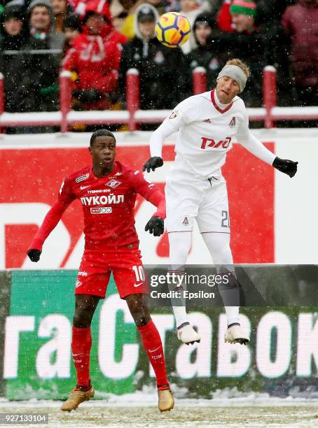 Vladislav Ignatyev of FC Lokomotiv Moscow vies for the ball with Quincy Promes of FC Spartak Moscow during the Russian Premier League match between...