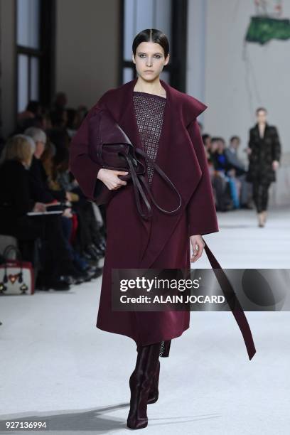 Model presents a creation for Akris during the 2018/2019 fall/winter collection fashion show on March 4, 2018 in Paris.